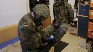 Two soldiers in German Flecktarn in gas masks wanking